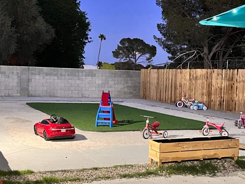Outdoor play area with ride-on toys and tricycles at a Christian daycare center in Las Vegas offering safe and fun activities.