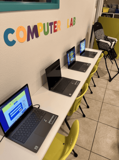 Preschool computer lab in Las Vegas featuring laptops and colorful chairs, supporting early STEM education for Pre-K students.