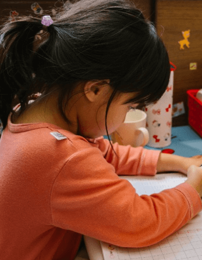 Young girl focused on learning activities during a flexible drop-in daycare session at Learning Space Christian Academy in Las Vegas.