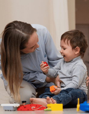 Teacher engaging with infant in a learning activity at one of the best infant day care programs in Las Vegas.