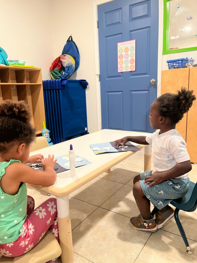 Kids working on an arts and crafts project inside a Las Vegas Christian childcare classroom.