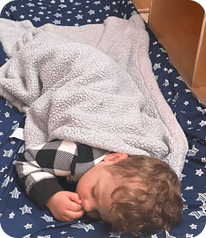 Infant peacefully napping under a soft blanket at a licensed infant day care center in Las Vegas NV.