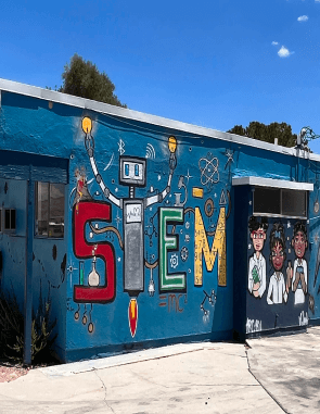 Colorful STEM-themed mural at Learning Space Christian Academy in Las Vegas, integrating science with Christian education.